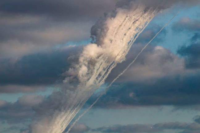 A picture taken from the southern Lebanese city of Tyre shows rockets being fired from the region toward Israel on October 11, 2024. - KAWNAT HAJU / AFP