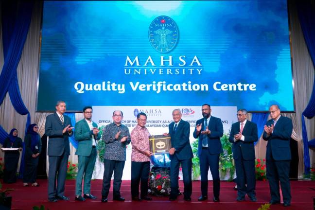 Mustapha (fourth from left) receiving a plaque at the launching of the QVC event.