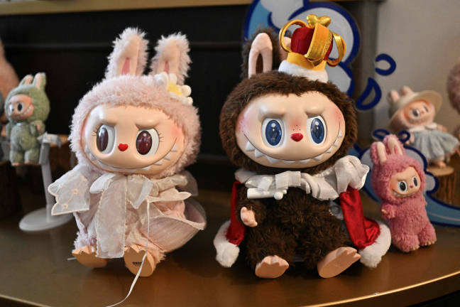 This picture taken on June 18, 2025 shows figures of the characters Mokoko (L) and Labubu in an exhibition room at Pop Mart’s theme park Pop Land in Beijing. - AFP