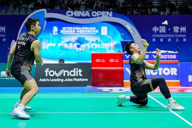 Malaysia’s Goh Sze Fei (L) and Nur Izzuddin (R) hit a return against Indonesia’s Muhammad Shohibul Fikri and Daniel Marthin during the men’s doubles semifinal match at the China Open Badminton tournament in Changzhou, in China’s eastern Jiangsu Province on September 21, 2024. - STRINGER / AFPpix