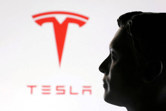 A 3D-printed miniature model of Elon Musk and the Tesla logo are seen in this illustration taken January 23, 2025. - REUTERSpix
