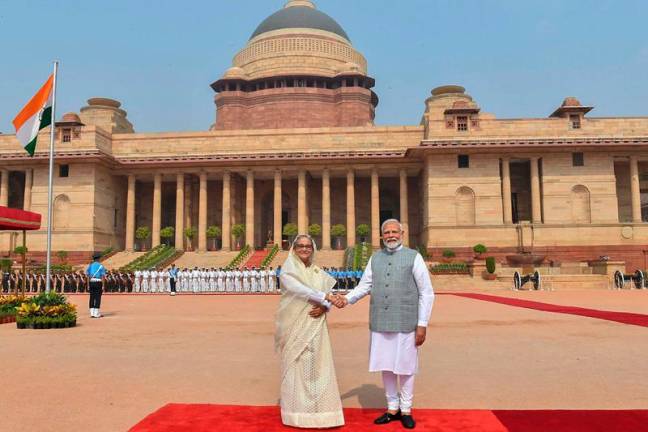 This handout photograph taken and released on June 22, 2024 by the Indian Press Information Bureau (PIB) shows India's Prime Minister Narendra Modi shaking hands with Bangladesh's counterpart Sheikh Hasina (L) after receiving her at the Presidential Palace Rashtrapati Bhavan in New Delhi on June 22, 2024. - AFP PHOTO /Indian Press Information Bureau (PIB)