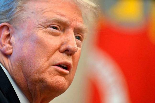 US President Donald Trump speaks to the press after signing an Executive Order at the Oval Office of the White House in Washington, DC on February 25, 2025. Trump signed an executive order on price transparency requirements on the health care industry to reinstate and strengthen them. He also signed an order on the supply of copper and foreign copper in the American market, the order charges Lutnick with looking at process to potentially impose tariffs or trade barriers. - Jim WATSON / AFP