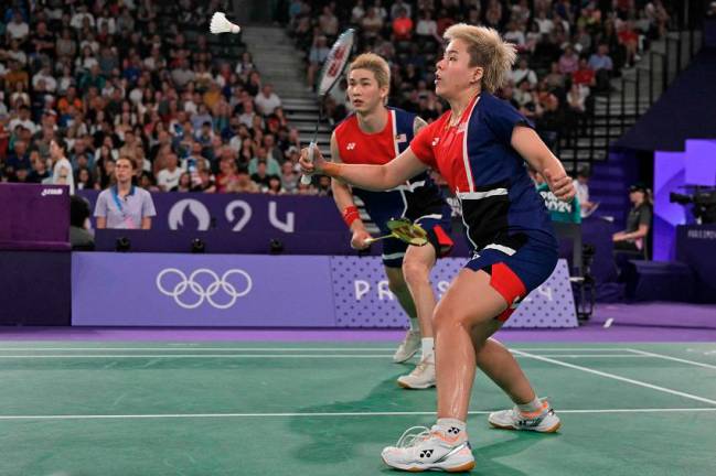 Malaysia’s Toh Ee Wei (right) plays a shot in the mixed doubles badminton group stage match against China during the Paris 2024 Olympic Games. – AFPPIX