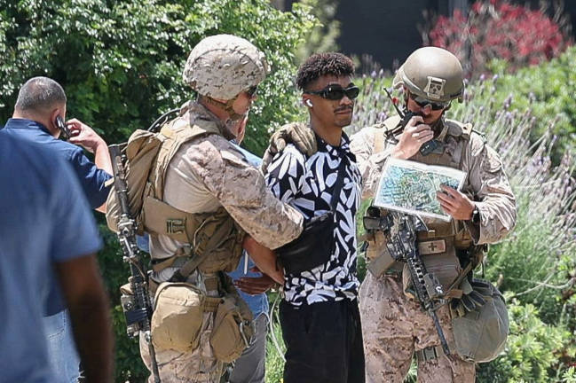 U.S. Marines detain a person outside the Wilshire Federal Building after Marines were deployed to Los Angeles, as protests against federal immigration sweeps continue, in Los Angeles, California, U.S. June 13, 2025. - REUTERSpix