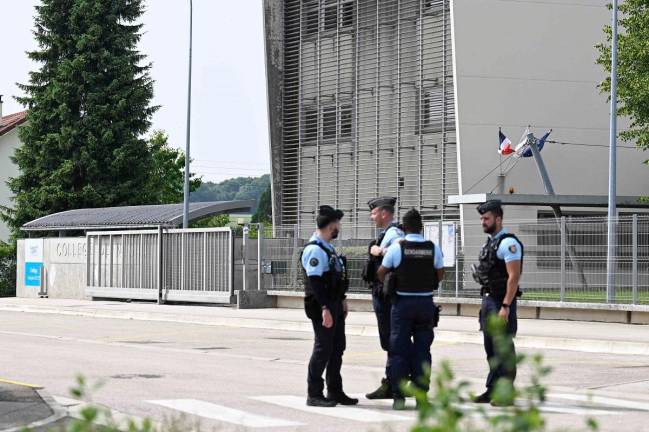 French gendarmes stand guard outside a secondary school, where a 31-year-old teaching assistant was stabbed with a knife by a 15-year-old pupil during a bag search in Nogent, eastern France on June 10, 2025. The teaching assistant, who died of her wounds, received several knife wounds just as classes were starting, and the alleged attacker, who was overpowered by gendarmes, “appears to be a student at the school,“ education officials said. - Jean-Christophe VERHAEGEN / AFP