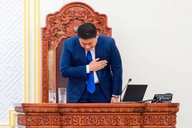 Mongolia's Prime Minister Luvsannamsrain Oyun-Erdene bows after losing his position in a vote in Ulaanbaatar, capital city of Mongolia on June 3, 2025. Mongolian Prime Minister Luvsannamsrain Oyun-Erdene resigned on June 3, a parliamentary statement said, after losing a confidence vote among lawmakers. The secret ballot followed days of protests in the capital Ulaanbaatar against alleged corruption. Oyun-Erdene will remain as caretaker prime minister until his successor is appointed within 30 days, the statement said. - Byambasuren BYAMBA-OCHIR / AFP