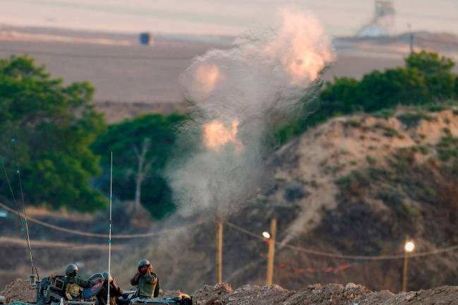 Israeli soldiers fire a mortar towards Gaza from their position near the border, as seen from Israel, June 2, 2025. - REUTERS/Amir Cohen