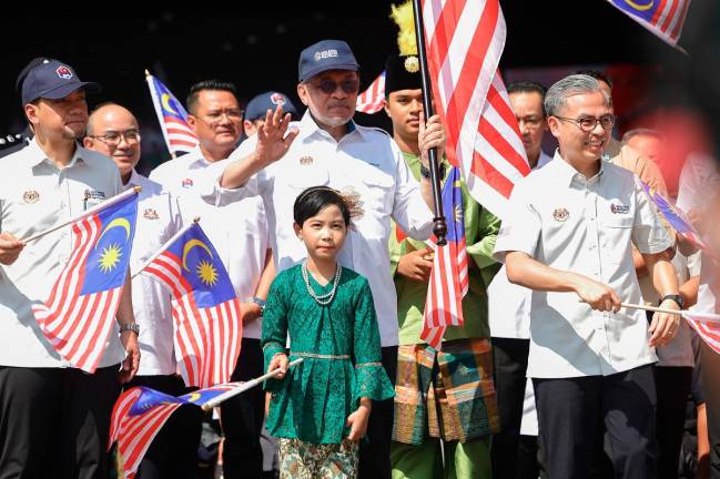 Prime Minister Datuk Seri Anwar Ibrahim during the departure of the Jalur Gemilang flag-flying convoy after the National Month 2025 Launching Ceremony at Dataran Tanjung Emas today.