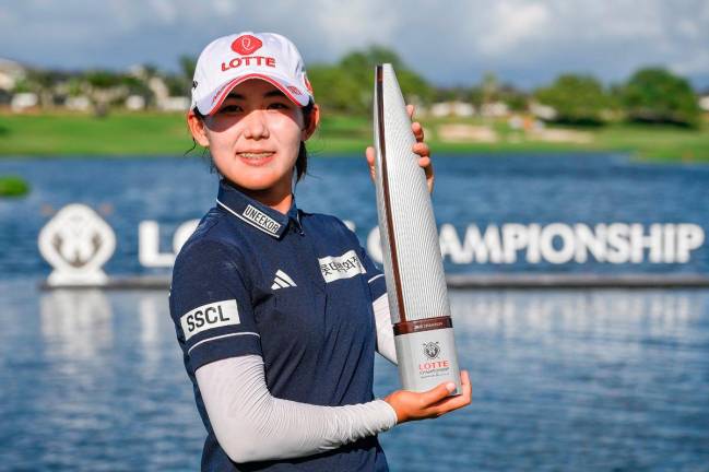 South Korean Hwang Youmin with the Lotte Championship trophy. - LPGAPIX