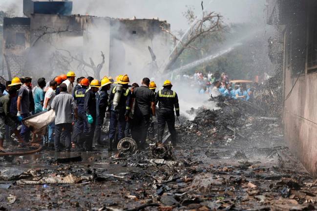 Firefighters work to put out a fire at the site where an Air India Boeing 787 Dreamliner plane crashed in Ahmedabad, India, June 12, 2025. - REUTERS/Amit Dave