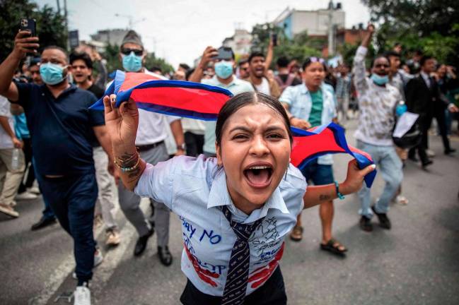A demonstrator shouts slogans during a protest outside the Parliament in Kathmandu on September 8, 2025, condemning social media prohibitions and corruption by the government. AFP