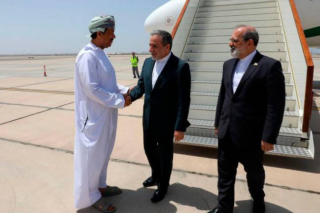 This handout picture provided by the Iranian Foreign Ministry on May 11, 2025, shows Iran’s Foreign Minister Abbas Araghchi (C) being welcomed upon his arrival in Muscat. Iran and the United States kicked off their fourth round of nuclear talks in Muscat, Iranian media reported on May 11, 2025. - AFP PHOTO / HO / IRANIAN FOREIGN MINISTRY