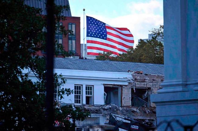Heavy machinery tears down a section of the East Wing of the White House as construction begins on President Donald Trump’s planned ballroom, in Washington, DC, on October 20, 2025. - AFP