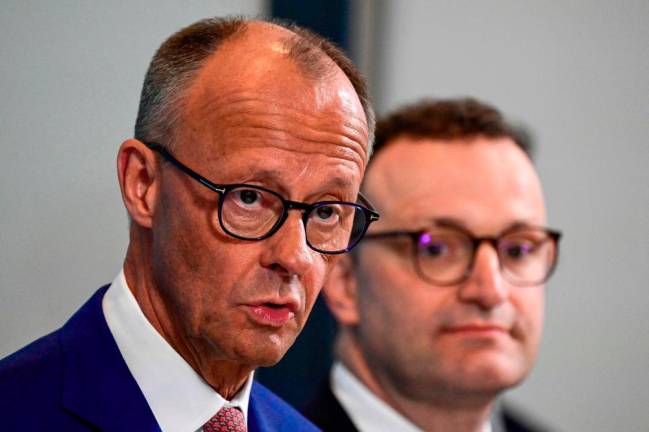 The leader of Germany's conservative Christian Democratic Union (CDU) party and designated chancellor Friedrich Merz (L) and newly elected Parliamentary group leader of Germany's Christian Democratic Union (CDU) Jens Spahn give a press statement after their parliamentary group meeting following the signing of a coalition agreement between CDU, CSU and Social Democratic Party (SPD) to form the country's new government, in Berlin on May 5, 2025. -AFPpix