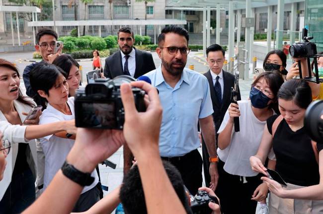 Singapore’s Workers’ Party Chief Pritam Singh walks outside the State Courts in Singapore February 17, 2025. - REUTERS/Edgar Su