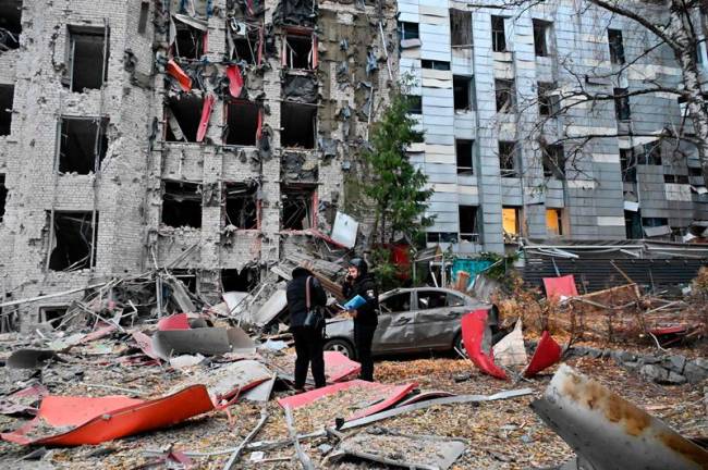 Police experts examine commercial and office buildings destroyed after the Russian strike on the center of Kharkiv 8, 2024, amid the Russian invasion of Ukraine. - SERGEY BOBOK / AFPpix