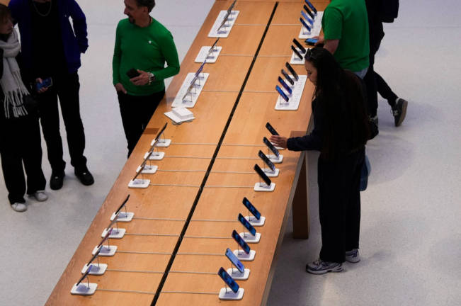 People browse iPhones at the Apple Fifth Avenue store, in New York City, U.S., May 23, 2025. - REUTERSpix