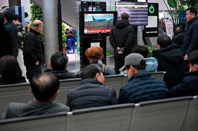 People and relatives of passengers of the crashed Jeju Air Boeing 737-800 series aircraft react at Muan International Airport in South Jeolla Province, some 288 kilometres southwest of Seoul on December 29, 2024. A Jeju Air plane carrying 181 people from Thailand to South Korea crashed on arrival, smashing into a barrier and bursting into flames, leaving all but two feared dead. (Photo by JUNG YEON-JE / AFP)