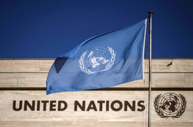 A flag flutters in wind at the main entrance of the building which houses the United Nations Offices in Geneva, on September 29, 2021. - AFPpic