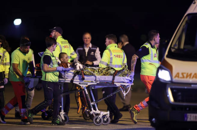 A boy is carried on a stretcher towards an ambulance, after the aircraft carrying Adam Al-Najjar, a Palestinian boy from Gaza who survived an Israeli strike that killed his nine siblings and his father, landed at Milan’s Linate Airport, Italy, June 11, 2025. - REUTERSpix