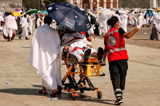 Medical team members evacuate a Muslim pilgrim, affected by the soarching heat, at the base of Mount Arafat, also known as Jabal al-Rahma or Mount of Mercy, during the annual hajj pilgrimage on June 15, 2024.