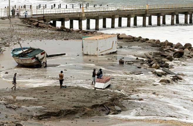 A fishing boat remains stranded after strong waves hit in Lobitos, Talara Province, Peru, on December 27, 2024. On December 28, Peru raised to 91 the number of ports closed, out of a total of 121, and restricted access to recreational beaches as heavy waves hit the northern and central coast of the country, authorities said. - Nicolas LANDA TAMI / AFP