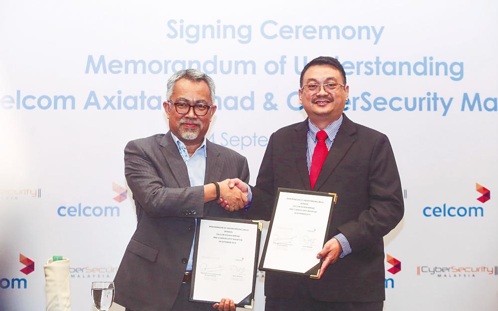 Idham (left) and Amirudin at the signing ceremony yesterday. – BBX IMAGES