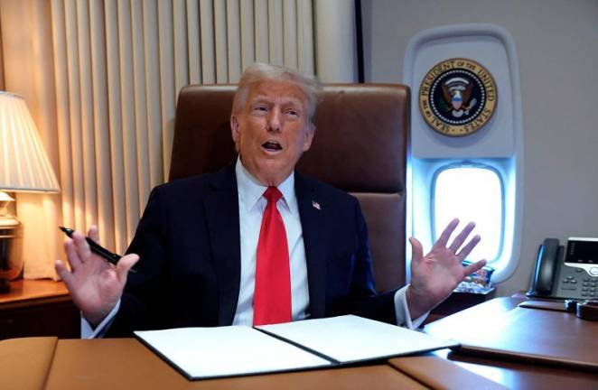 U.S. President Donald Trump speaks to reporters before signing a proclamation renaming the Gulf of Mexico to the Gulf of America, while flying over the gulf aboard Air Force One en route to New Orleans to attend the Super Bowl, February 9, 2025. - REUTERS/Kevin Lamarque