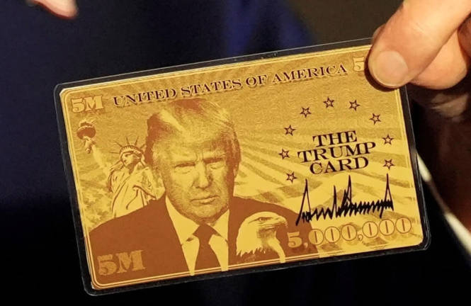 “The Trump Card” held by U.S. President Donald Trump as he speaks with journalists onboard Air Force One en route to Miami, Florida, U.S., April 3, 2025. - REUTERSpix