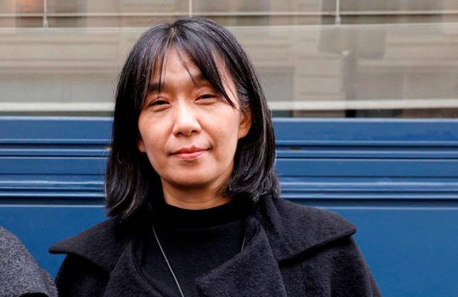 This photo taken on November 9, 2023 shows South Korean author Han Kang as she poses after co-winning (jointly with Portuguese author Lidia Jorge) the Medicis Prize for a foreign novel in Paris. South Korean author Han Kang won the Nobel Prize in Literature 2024, it was announced on October 10, 2024. - Geoffroy VAN DER HASSELT / AFP / ALTERNATIVE CROP