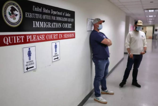 Plainclothes federal agents with US Immigration and Customs Enforcement wait in a hallway outside of an immigration courtroom in New York City. - AFPpix