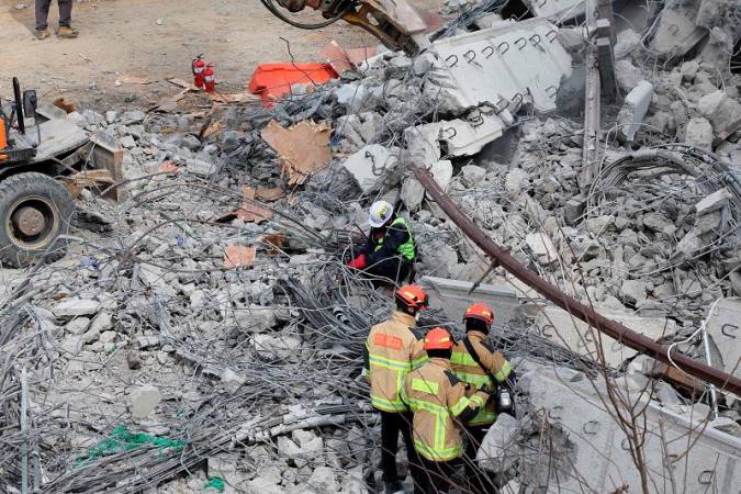 Rescue workers participate in a salvage operation at a collapsed highway construction site in Cheonan, South Korea, February 25, 2025. - REUTERS/Kim Hong-ji