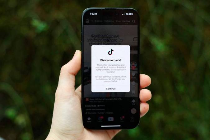 In this photo illustration an iPhone displays a popup message on the social media platform TikTok on January 19, 2025 in Washington, D.C. The popular platform is now welcoming users back after being unavailable on January 18 to users inside of the United States after a U.S. Supreme Court ban took effect. - Kayla Bartkowski / GETTY IMAGES NORTH AMERICA / AFP
