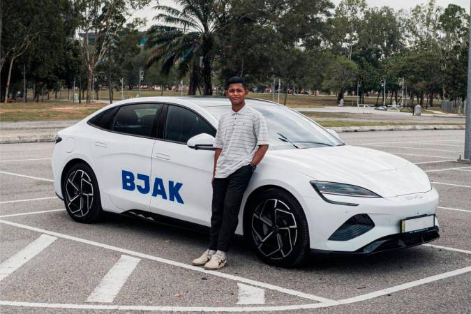 Halimie bin Abdul, 20, celebrates after being named the grand prize winner of BJAK’s 8.8 Mega Giveaway, taking home a BYD Seal electric car worth over RM180,000.