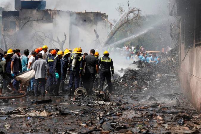 Firefighters work to put out a fire at the site where an Air India Boeing 787 Dreamliner plane crashed in Ahmedabad, India, June 12, 2025. - REUTERS/Amit Dave