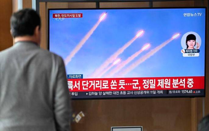 A man watches a television screen showing a news broadcast with file footage of a North Korean missile test, at a train station in Seoul on March 10, 2025. REUTERSpix.