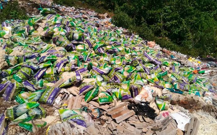 The bags of rice found strewn at the dumpsite in Temerloh, Pahang.