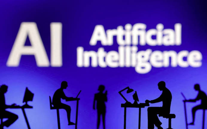 Figurines with computers and smartphones are seen in front of the words “Artificial Intelligence AI” in this illustration taken, February 19, 2024. - REUTERS