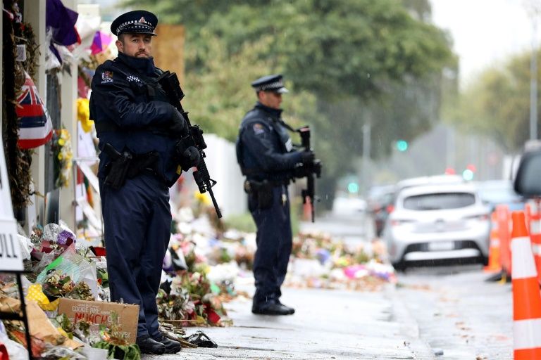 Armed police officers stand guard outside one of the mosques where some 50 people were killed by a self-avowed white supremacist gunman on March 15 in Christchurch. — AFP
