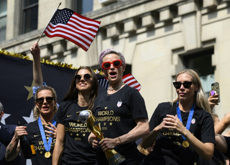 In this photo taken on July 10, 2019 Megan Rapinoe (C) and other members of the World Cup-winning US women’s team take part in a ticker tape parade in New York. — AFP