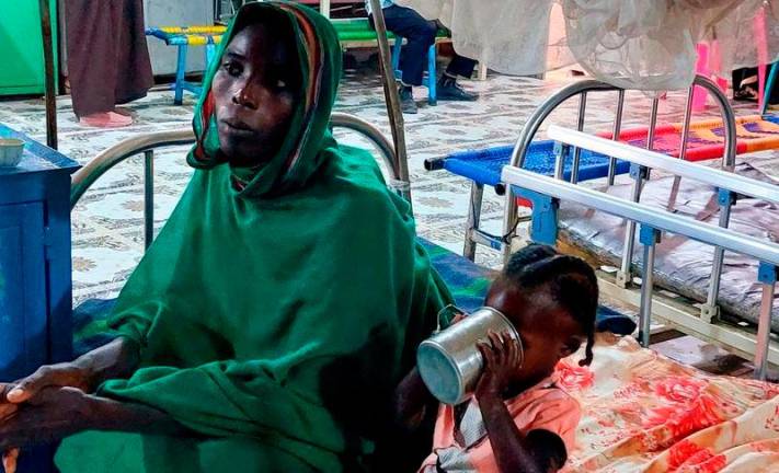 Pix for illustration purposes only/A woman and a child sit waiting at a nutrition centre at the Kalma camp for the displaced just outside Nyala, the provincial capital of South Darfur state, on November 20, 2022. AFPPIX