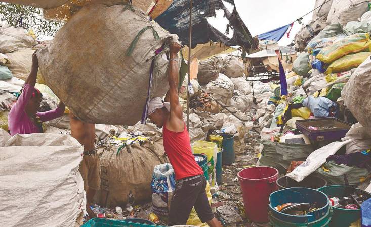 In many cities, informal waste pickers perform the essential work of recovering recyclables. – AFPpix