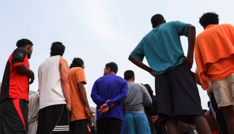 Multinational victims of scam centres queue to get food at a shelter as they wait for their embassies to pick them up, in Tak province, Thailand February 19, 2025. - REUTERSpix