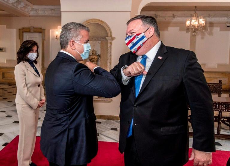 Colombian President Ivan Duque (Left) and US Secretary of State Mike Pompeo greeting each other with an elbow bump at Narino Presidential Palace in Bogota. — AFP