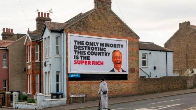 A view shows a billboard with an image of Reform party leader Nigel Farage, in Ramsgate, Britain, May 2, 2025. Everyone Hates Elon/Handout via REUTERSpix
