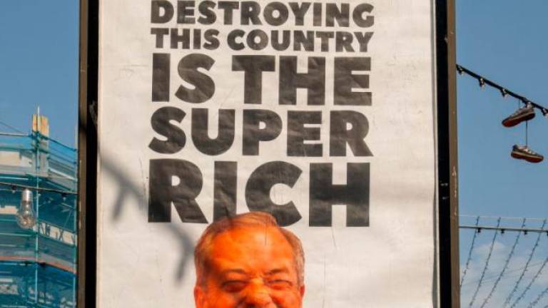A view shows a billboard with an image of Reform party leader Nigel Farage, in Ramsgate, Britain, May 2, 2025. Everyone Hates Elon/Handout via REUTERSpix