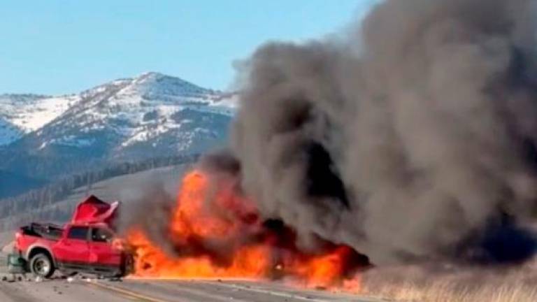 Flames rise near a pickup truck following a two-vehicle crash with multiple fatalities, according to Idaho State Police, in Island Park, Idaho, U.S., May 1, 2025. REUTERSpix