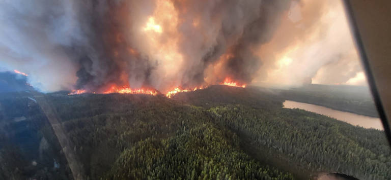 Smoke rises from the WE017 wildfire, which has prompted a state of emergency and evacuation of Sherridon, Manitoba, Canada May 27, 2025. - Handout via REUTERS.