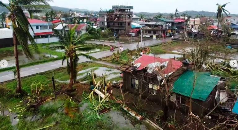 This frame grab from handout video footage taken and released on November 17, 2024 through the courtesy of John Marshal Aquino Facebook page shows aerial view of destroyed houses in Panganiban town, Catanduanes province, after Super Typhoon Man-yi hit the province. Super Typhoon Man-yi uprooted trees, brought down power lines and ripped off corrugated iron roofing as it swept across the storm-weary Philippines on November 17, following an unusual streak of violent weather. - AFP PHOTO / JOHN MARSHAL AQUINO